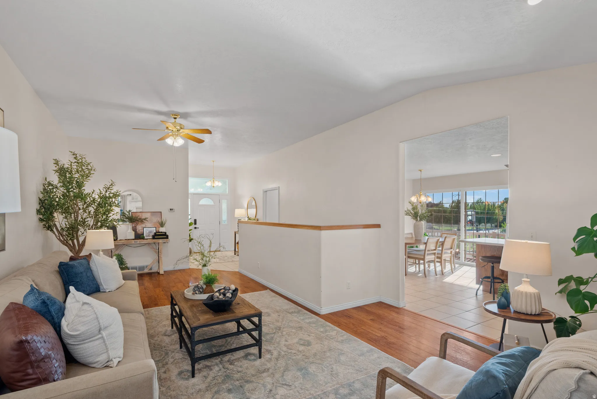 Wood-finish flooring in the living area with a ceiling fan