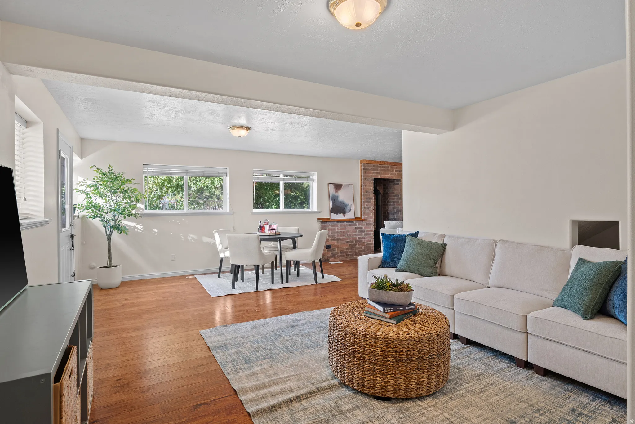 Wood-finish flooring, white walls, and a recessed ceiling light fixture