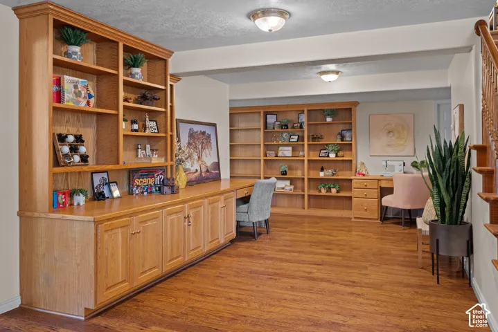 Wood-finish flooring with extensive built-in cabinetry and shelving