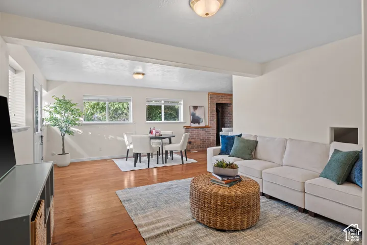 Wood-finish flooring, white walls, and a recessed ceiling light fixture