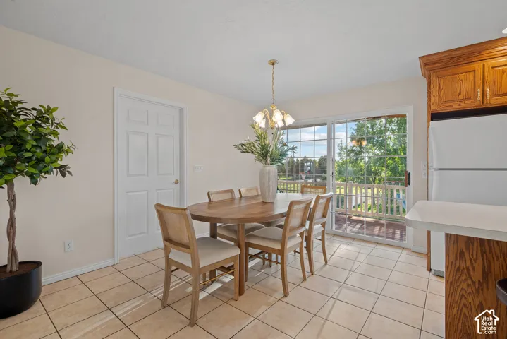Tile flooring, sliding glass door, overhead lighting fixture, and oak cabinetry