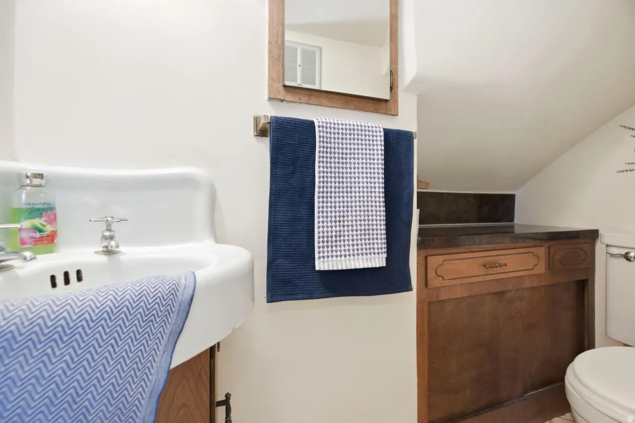 White ceramic sink with chrome faucet- half bath off of kitchen