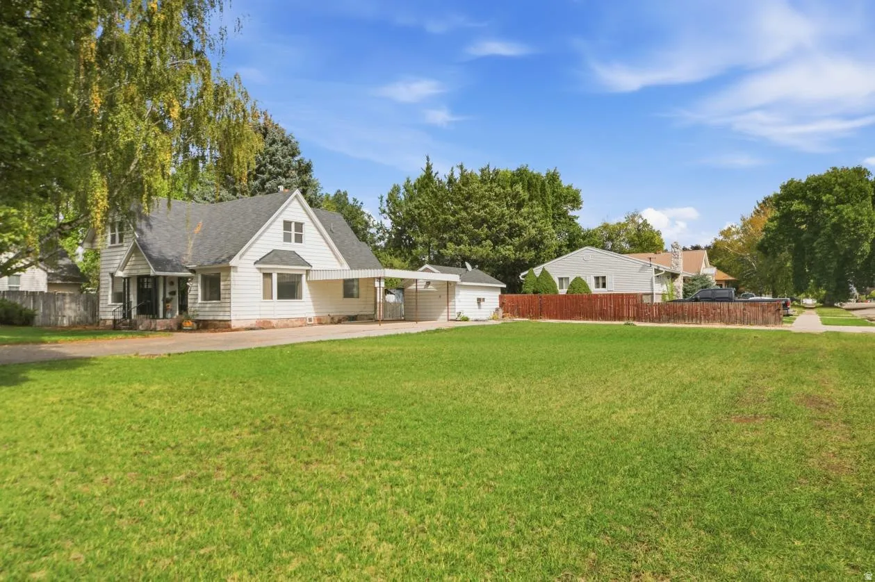 White clapboard exterior with an attached carport