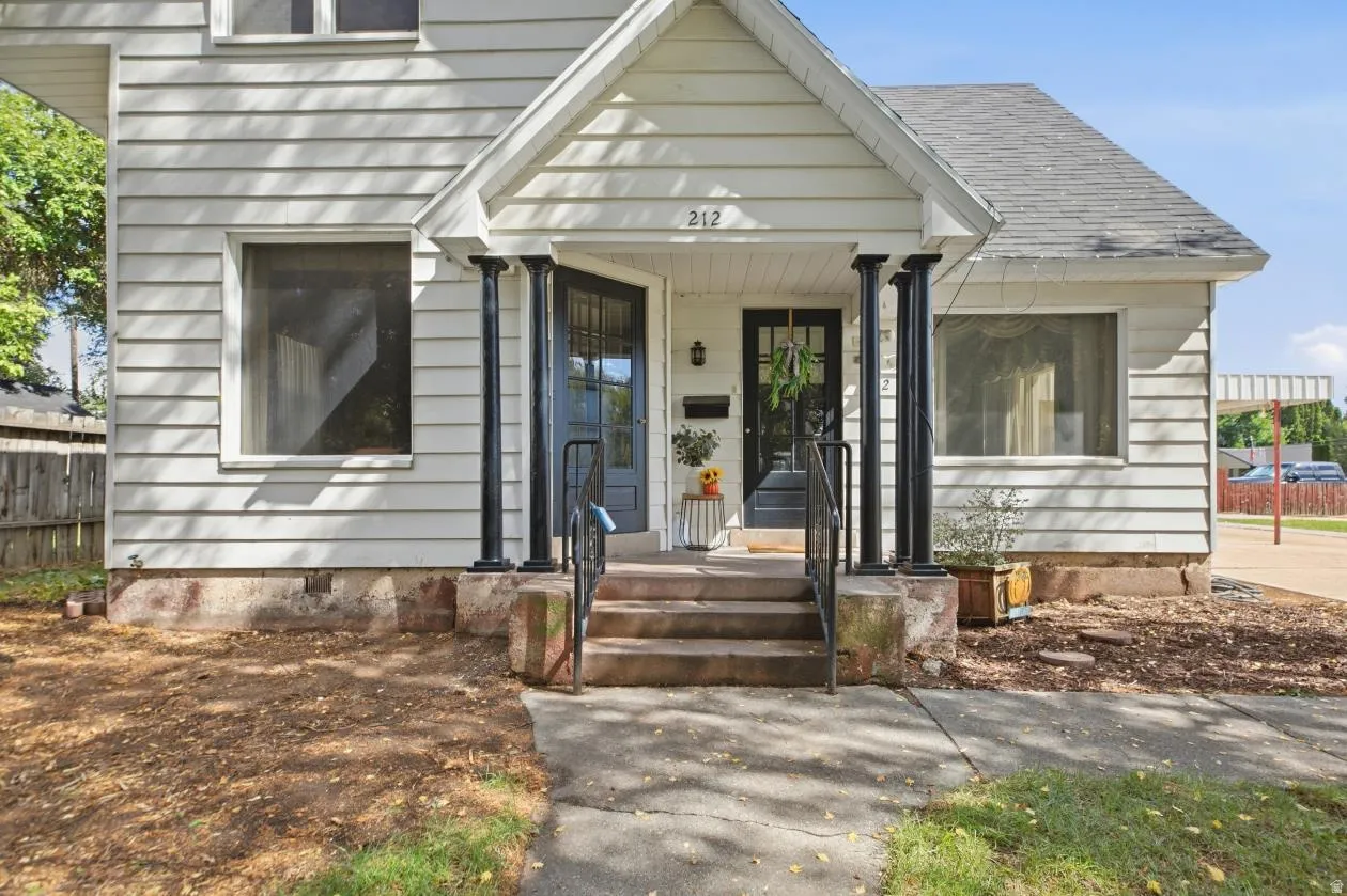 White siding exterior with a gabled roofline