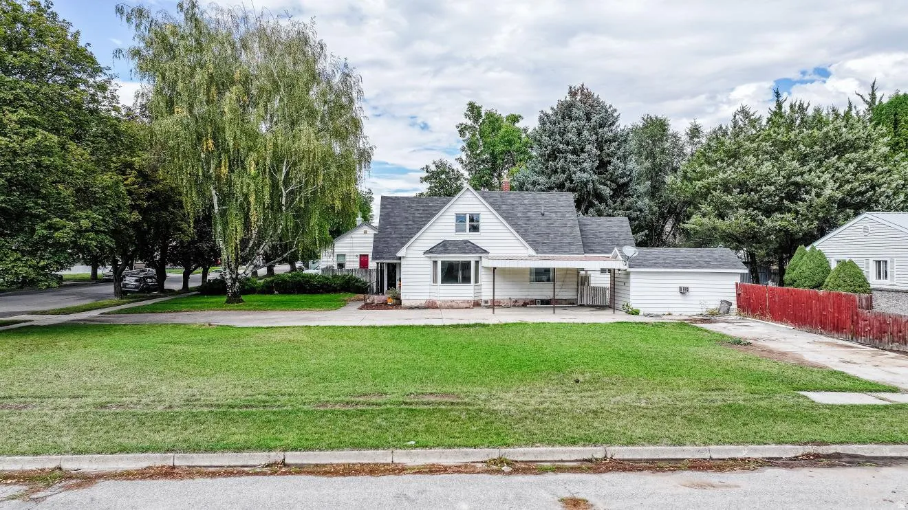 Single-story residence with white siding and a dark shingled roof