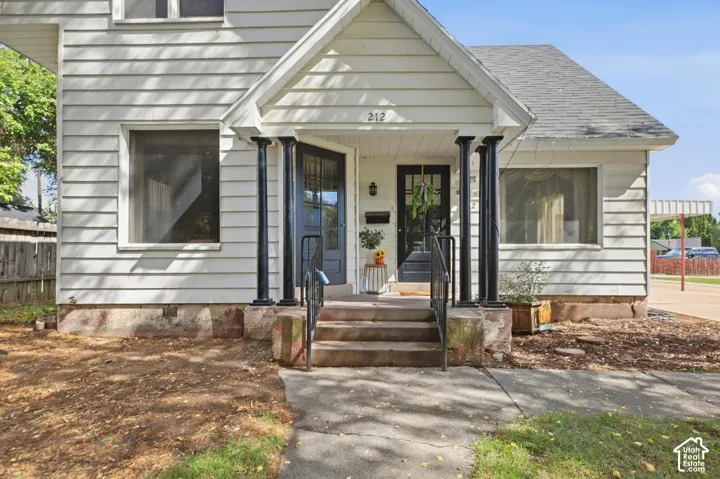 White siding exterior with a gabled roofline