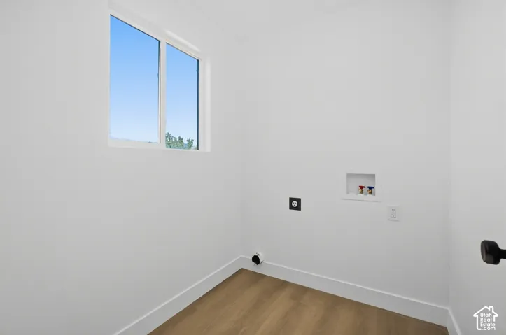 Bright room featuring wood-finish flooring and a white-framed window