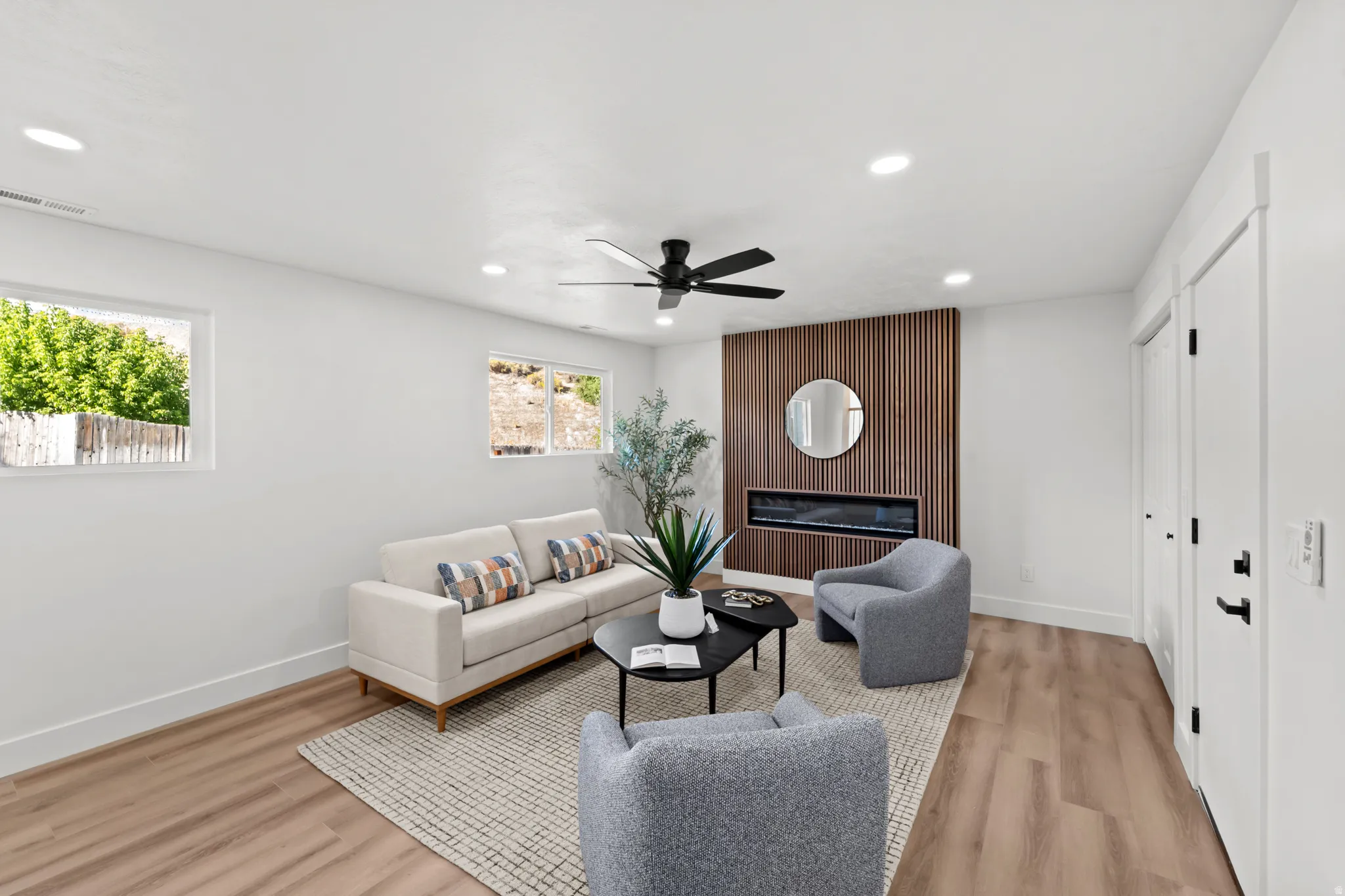 Recessed lighting, wood-finish flooring, and a modern ceiling fan