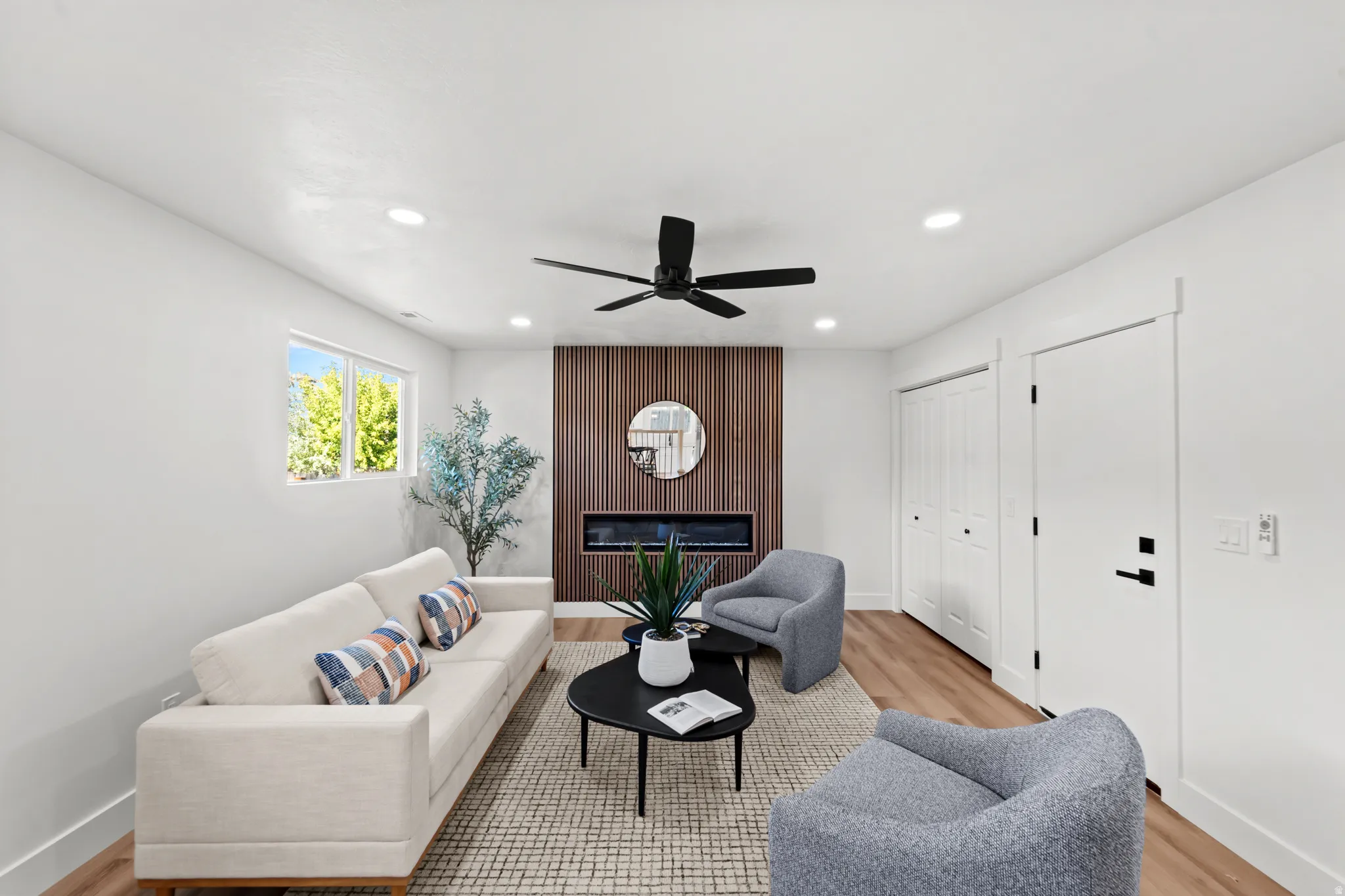 Wood-finish flooring, recessed lighting, and a contemporary ceiling fan