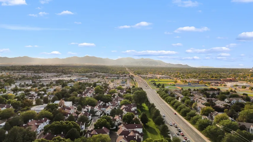 Expansive residential area featuring a prominent thoroughfare and abundant mature trees