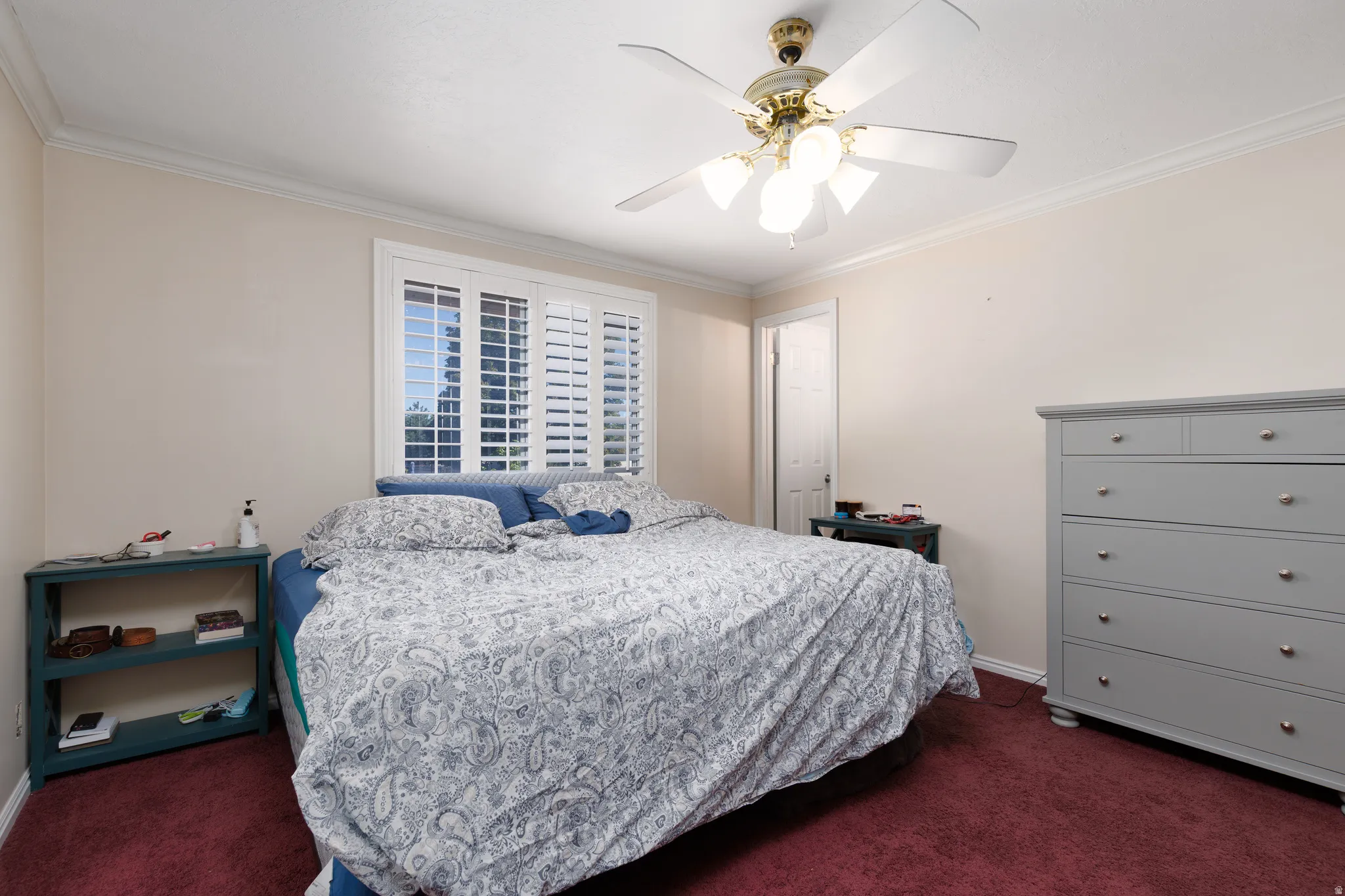 White window shutters, crown molding, and ceiling fan with integrated lighting