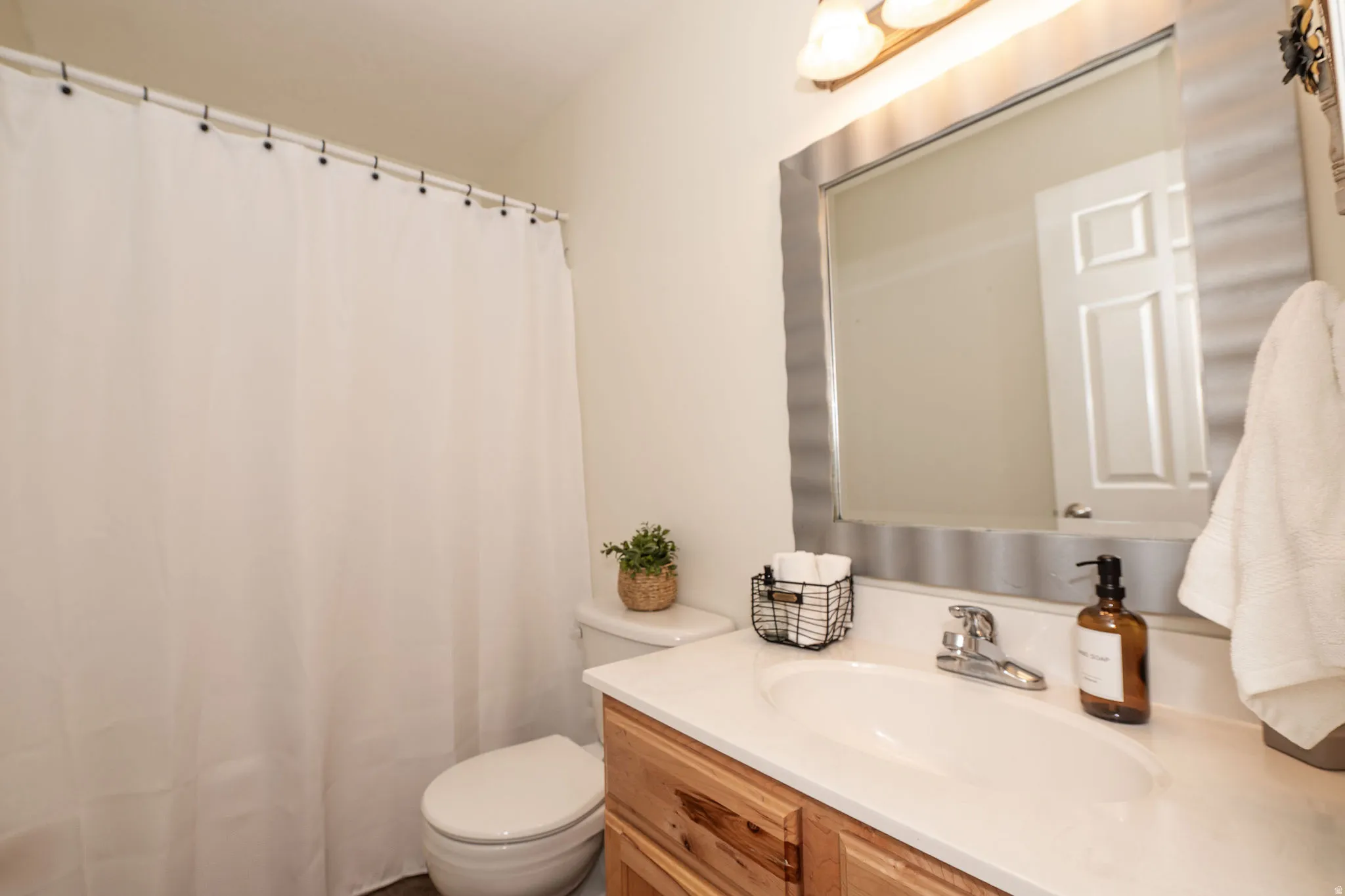 Vanity with a single basin, chrome faucet, and integrated countertop