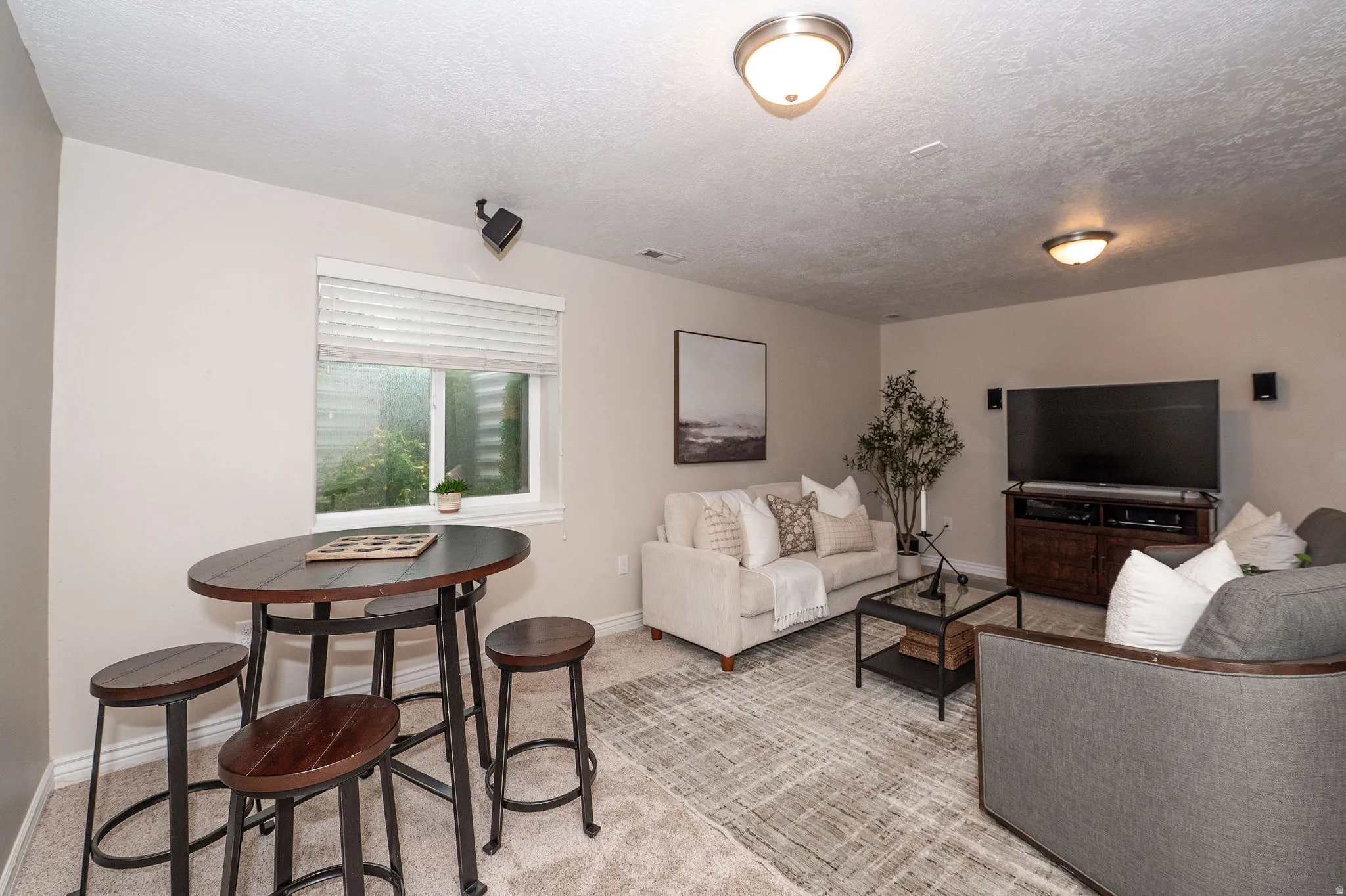 Recessed window with white blinds, neutral wall paint, and overhead lighting fixtures