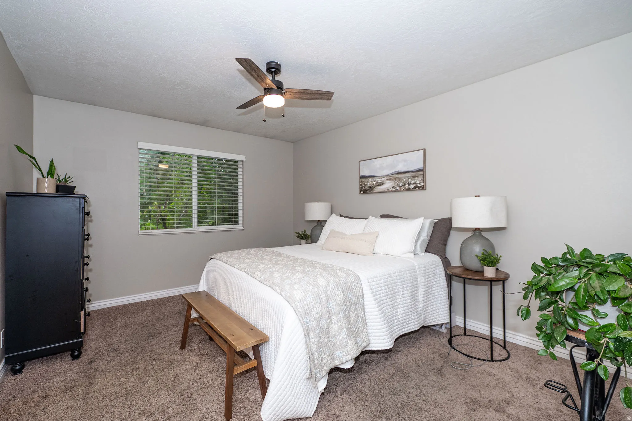 Neutral-toned walls complement the carpeted flooring