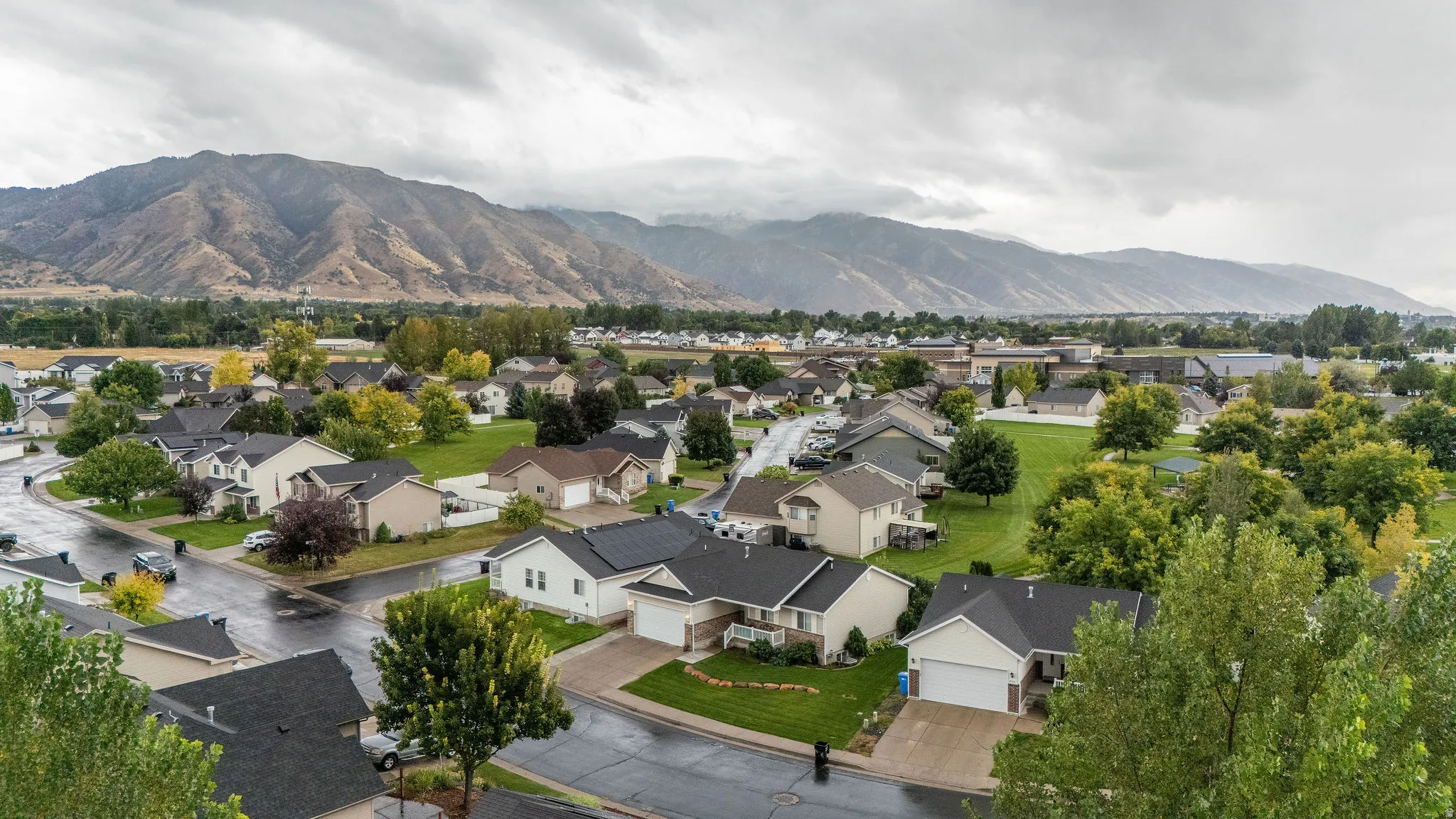Residential neighborhood featuring established homes, paved streets, and mature trees
