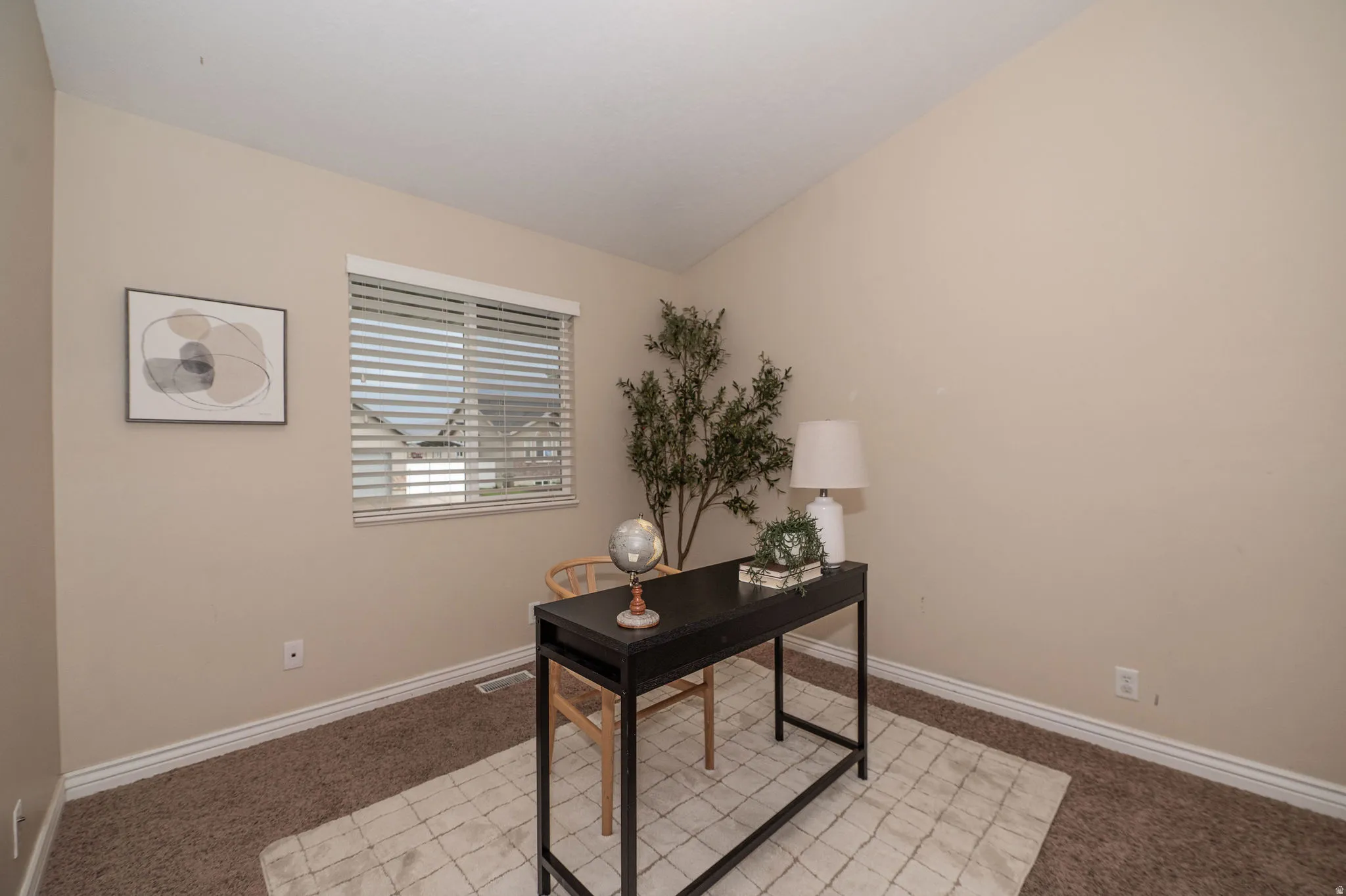 Vaulted ceiling, window with blinds, neutral wall paint, white trim, and carpeted flooring
