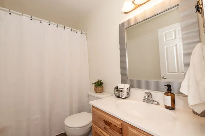Vanity with a single basin, chrome faucet, and integrated countertop