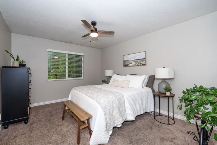 Neutral-toned walls complement the carpeted flooring
