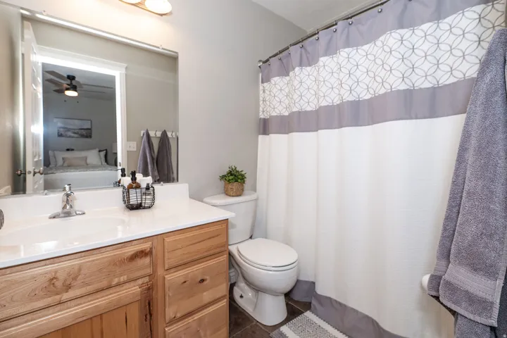 Vanity with a single basin sink and a light-toned countertop