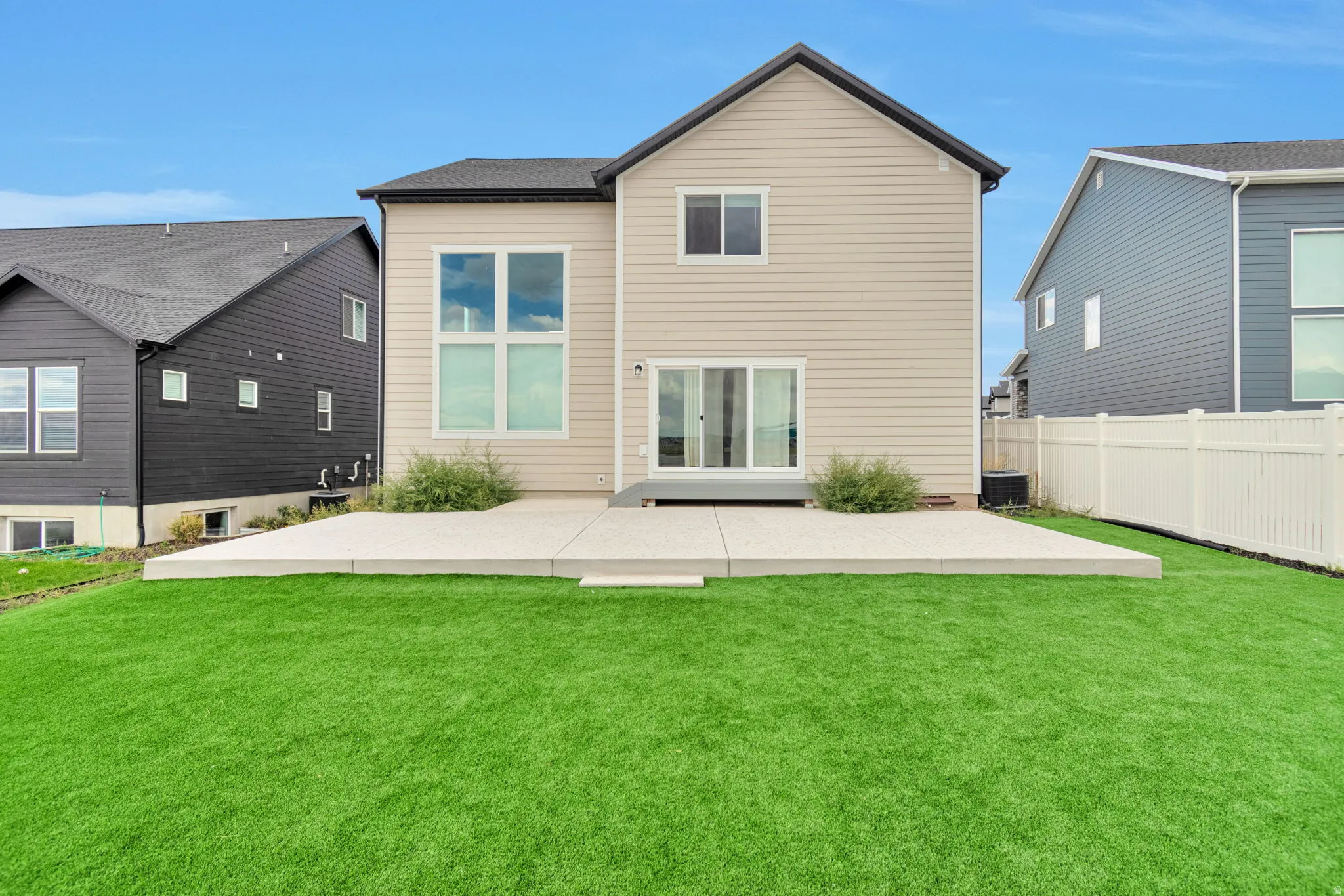 Expansive concrete patio with direct access to a level lawn