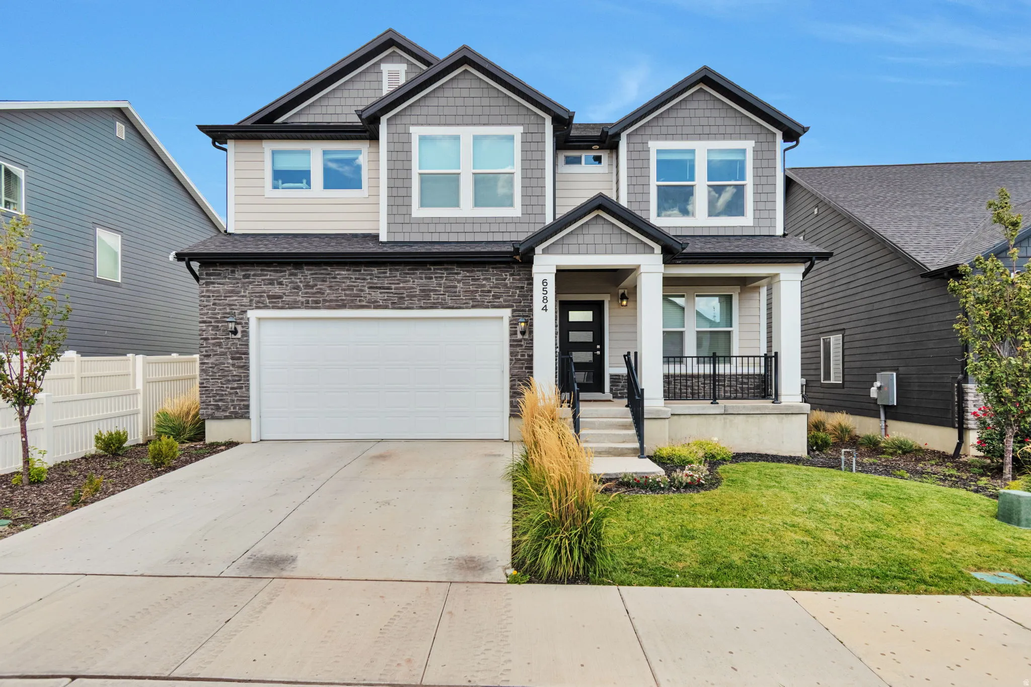 Contemporary two-story exterior with stone and siding facade