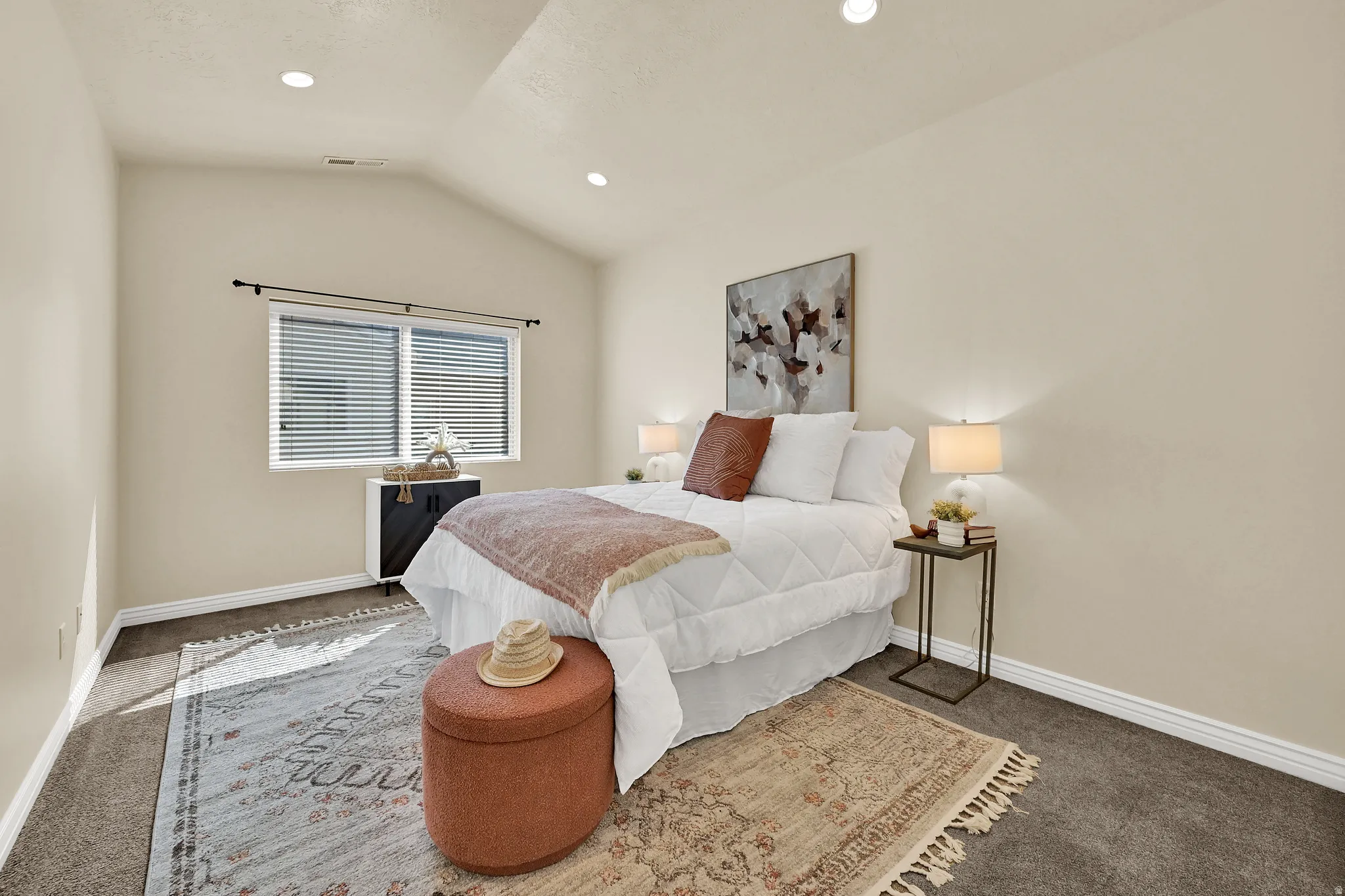 Vaulted ceiling, recessed lighting, double window with blinds, dark carpet, and white trim