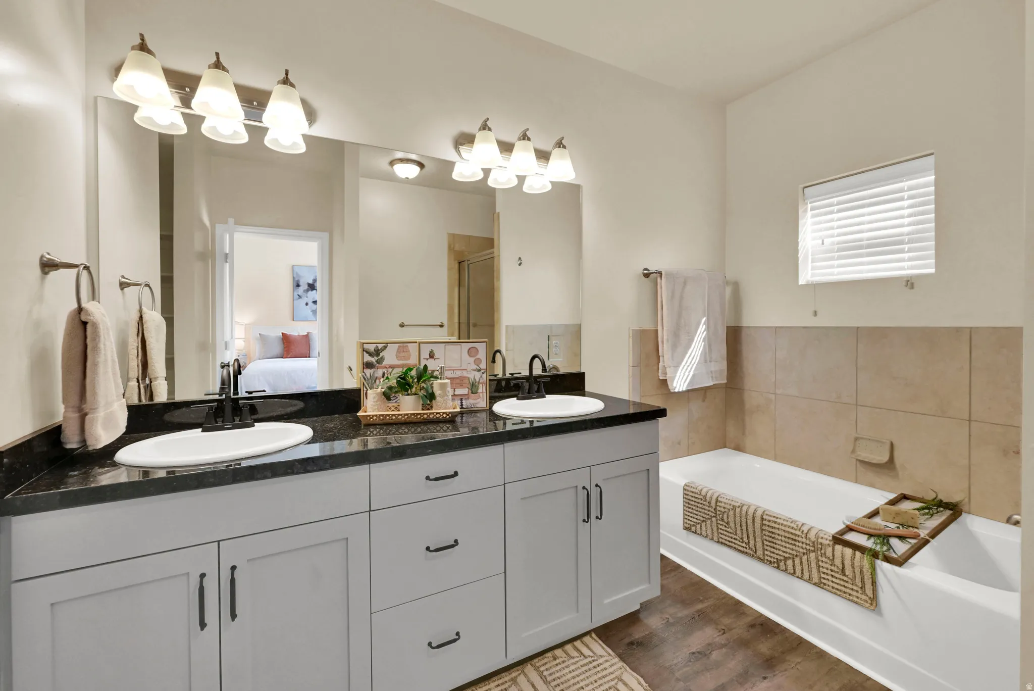 Dual vanity with dark countertops and undermount sinks