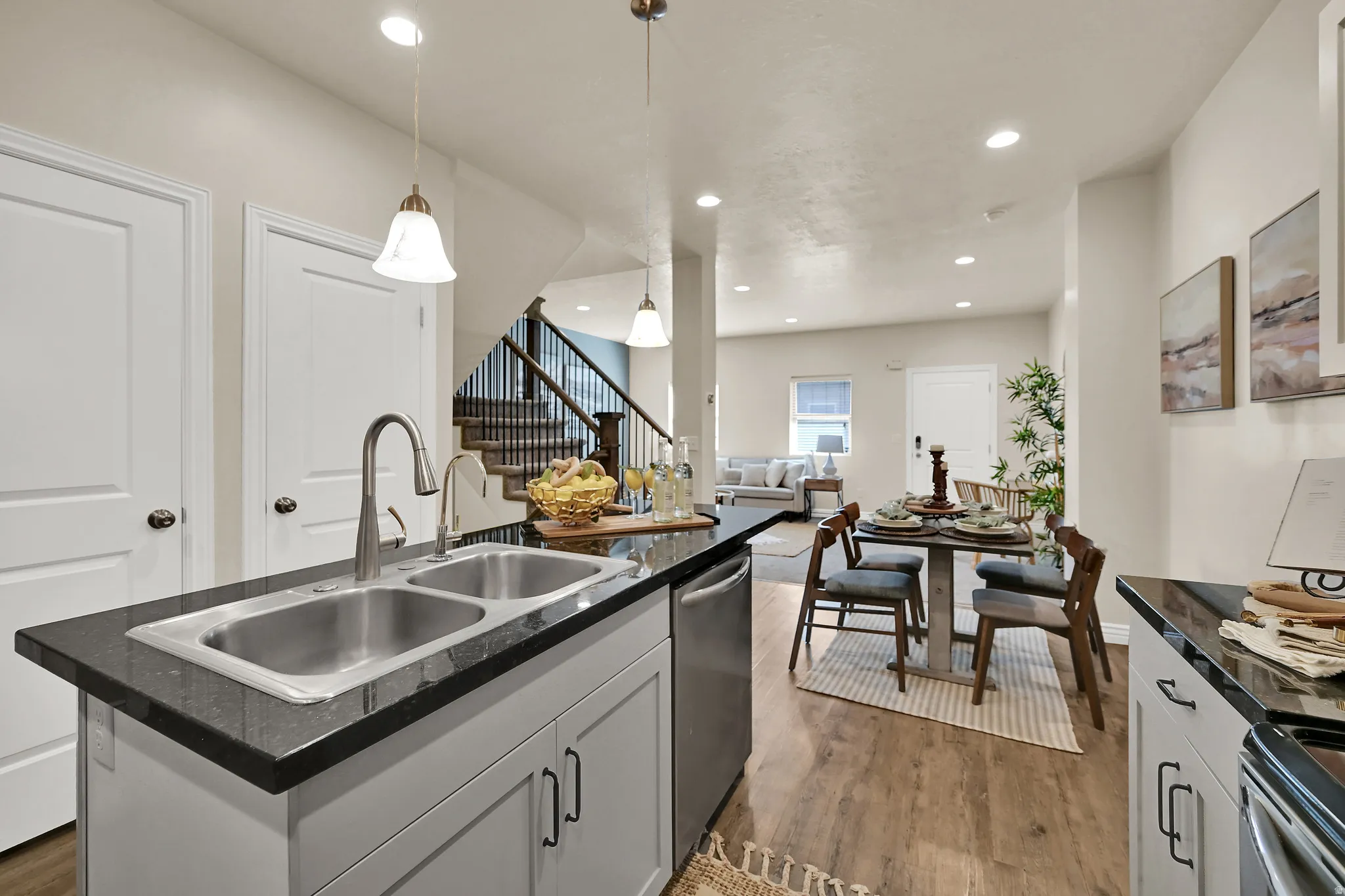 Kitchen island with dual stainless steel sink and dark countertops