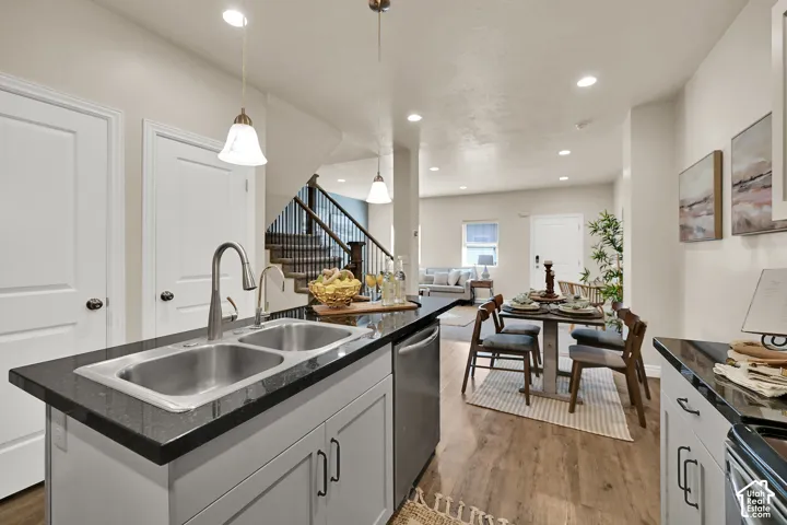 Kitchen island with dual stainless steel sink and dark countertops