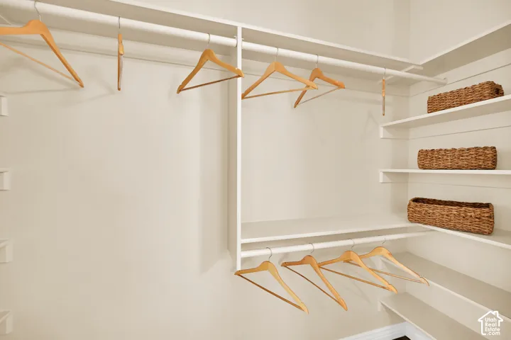 Built-in closet system featuring multiple hanging rods and integrated shelving