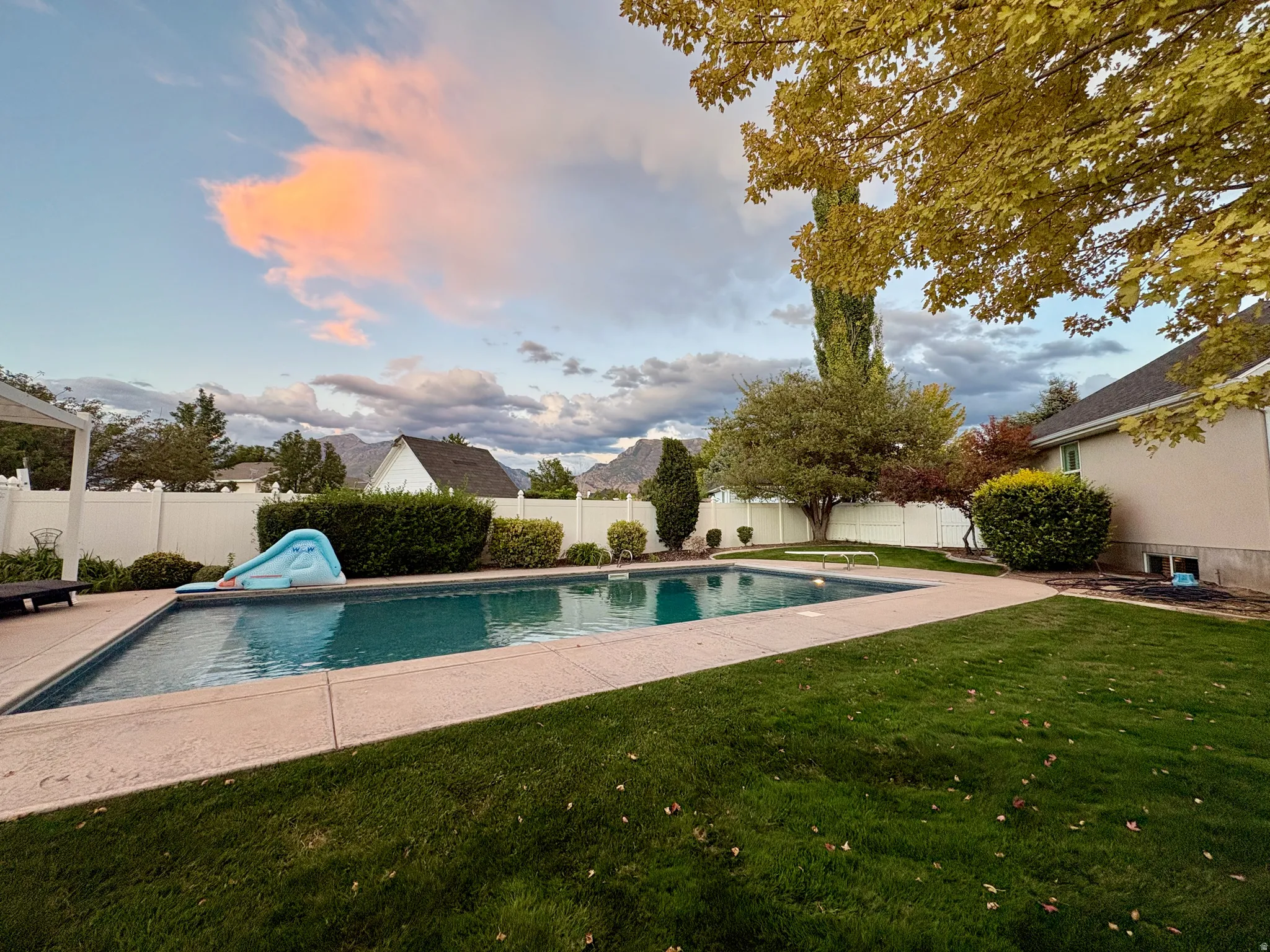 Rectangular in-ground swimming pool with surrounding concrete decking