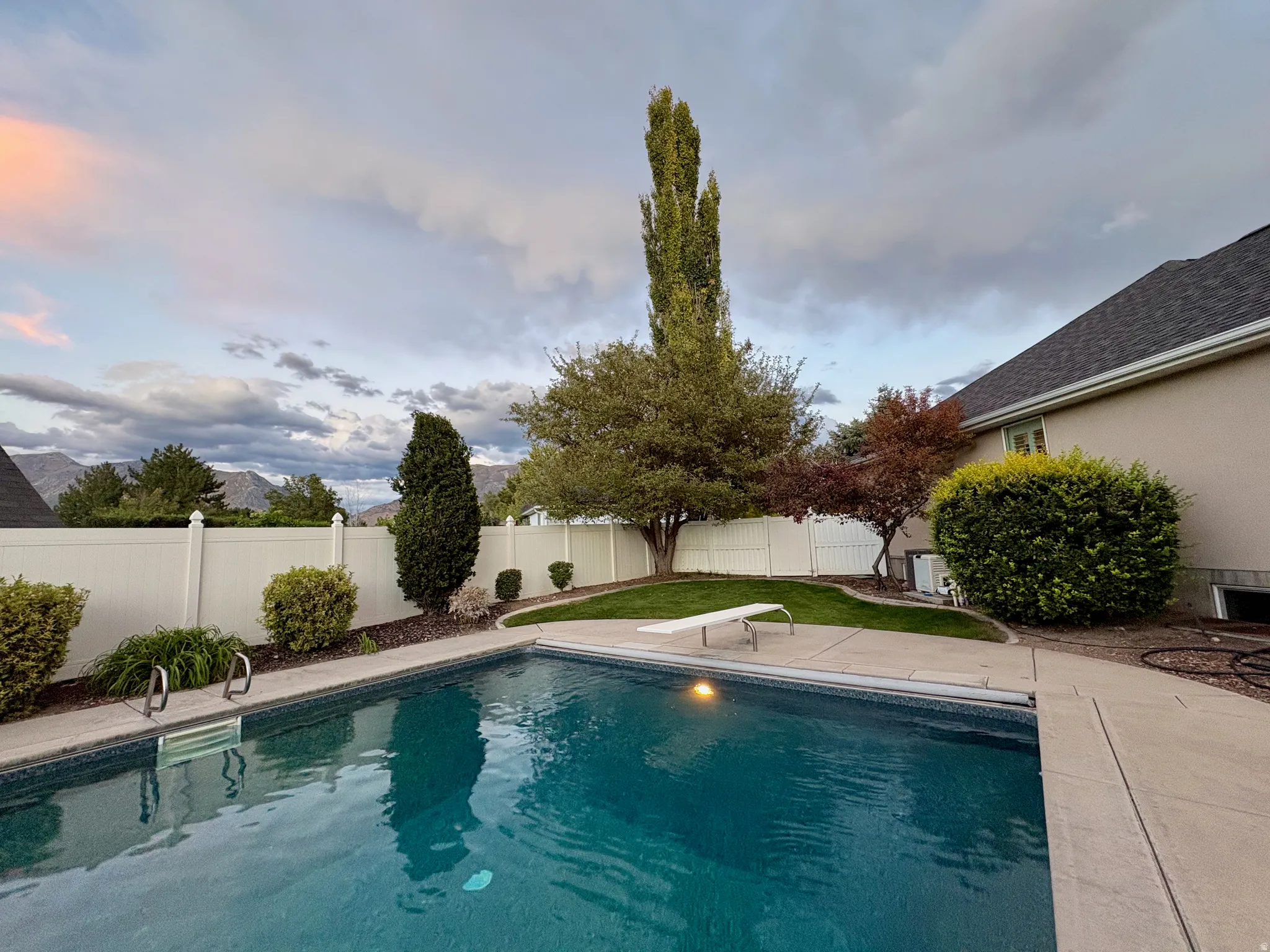 In-ground swimming pool with diving board
