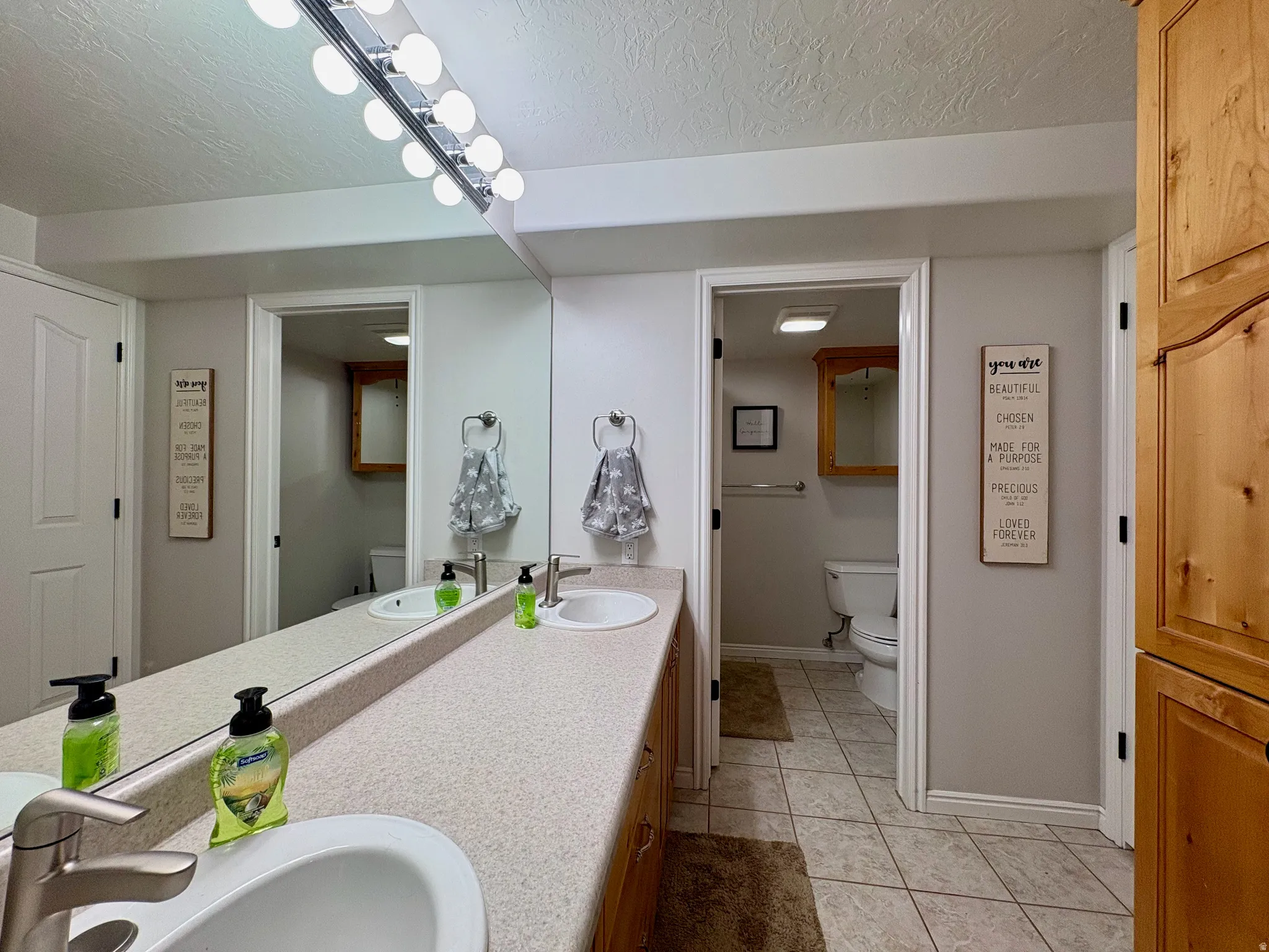 Dual vanity with integrated sinks, brushed nickel faucets, and a large wall mirror