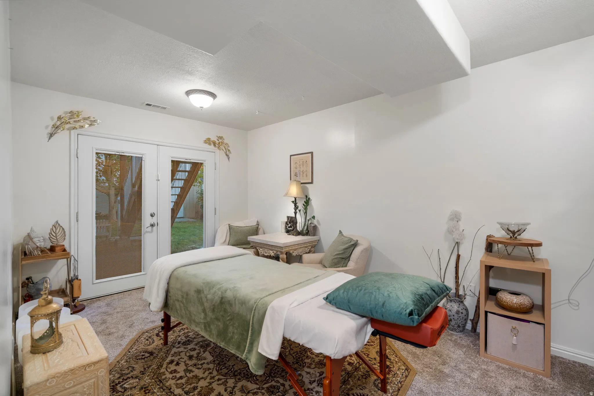 White painted walls with recessed lighting and a ceiling beam
