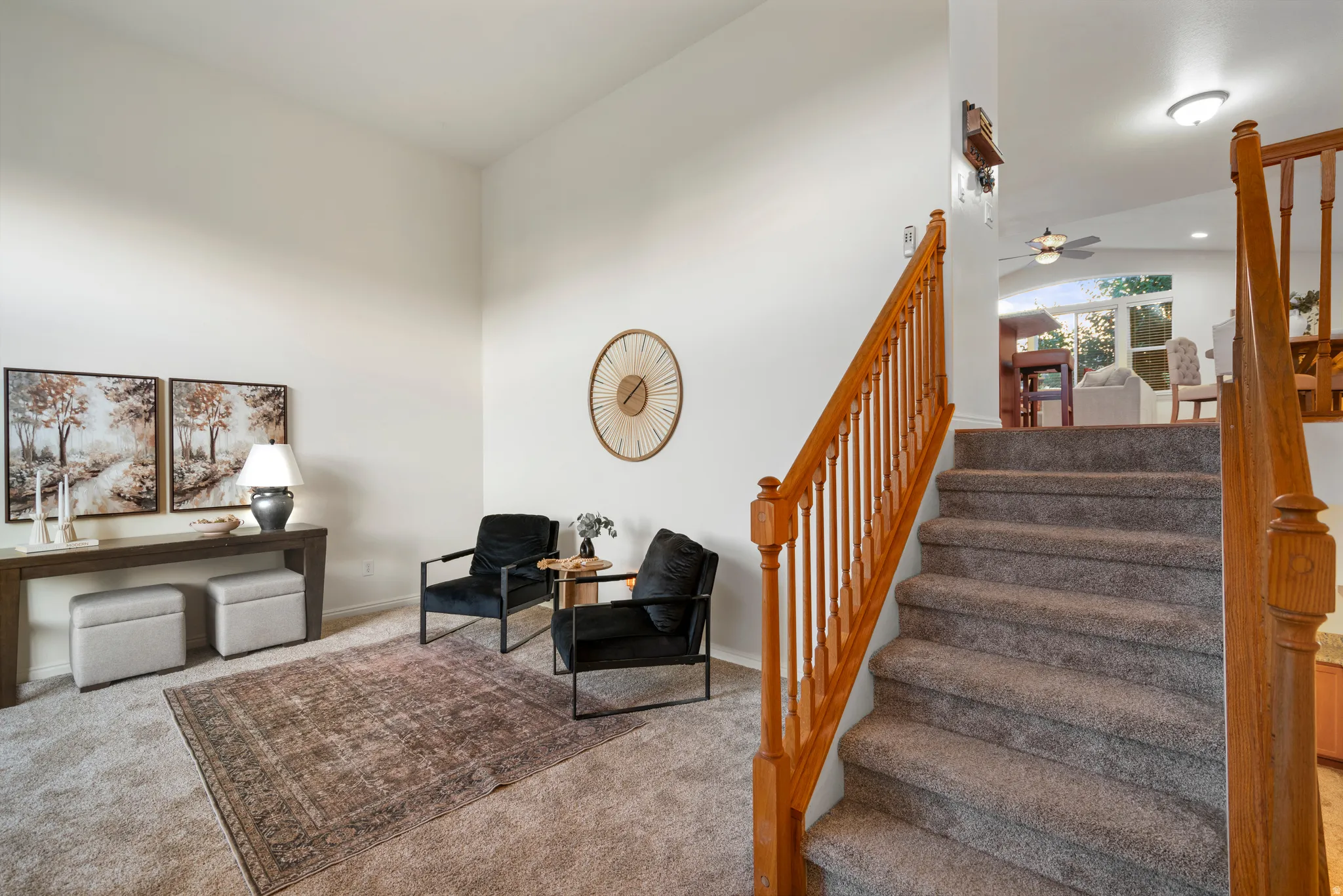Carpeted staircase with wood banister
