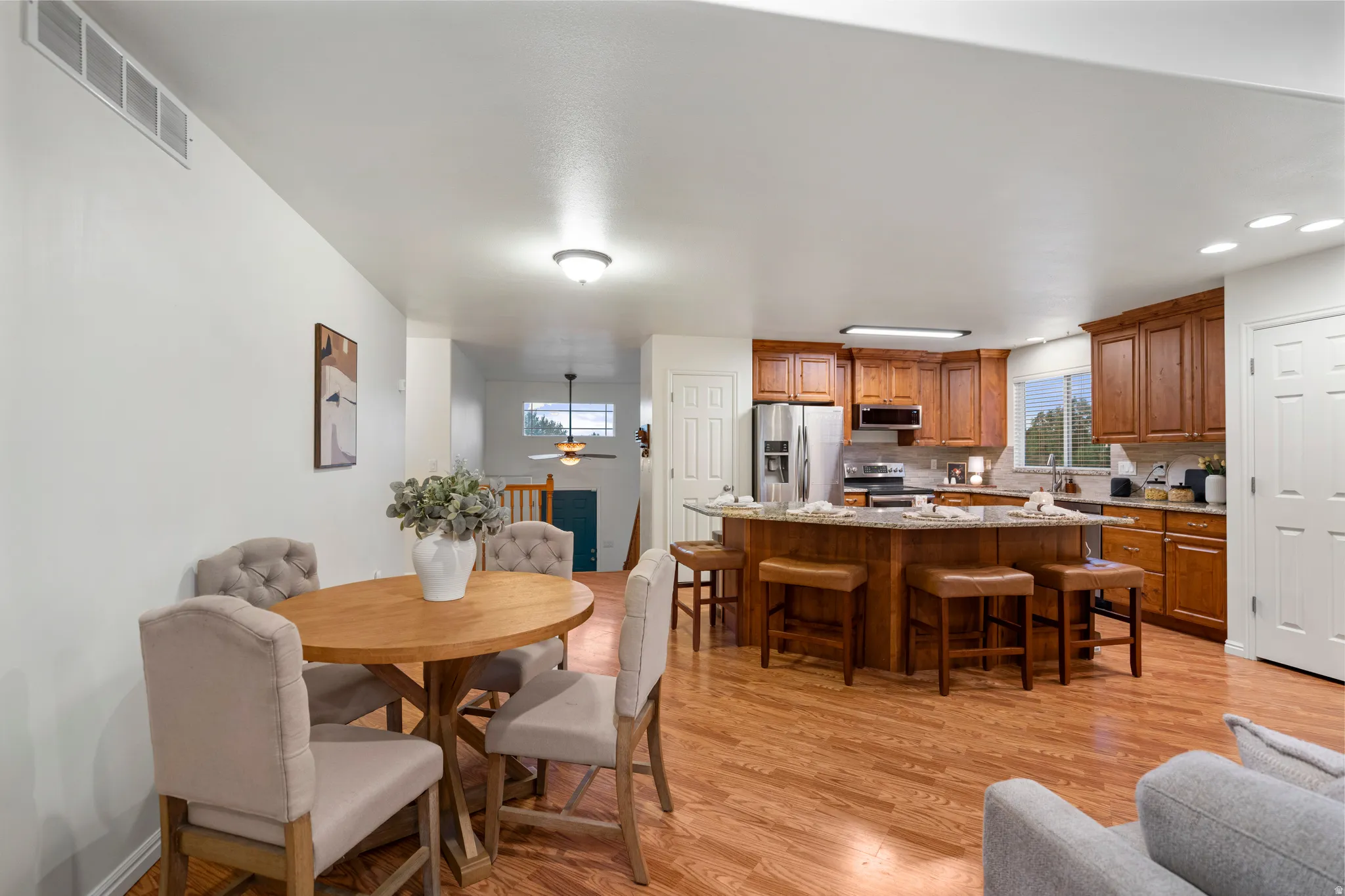 Open-concept living space with wood-finish flooring