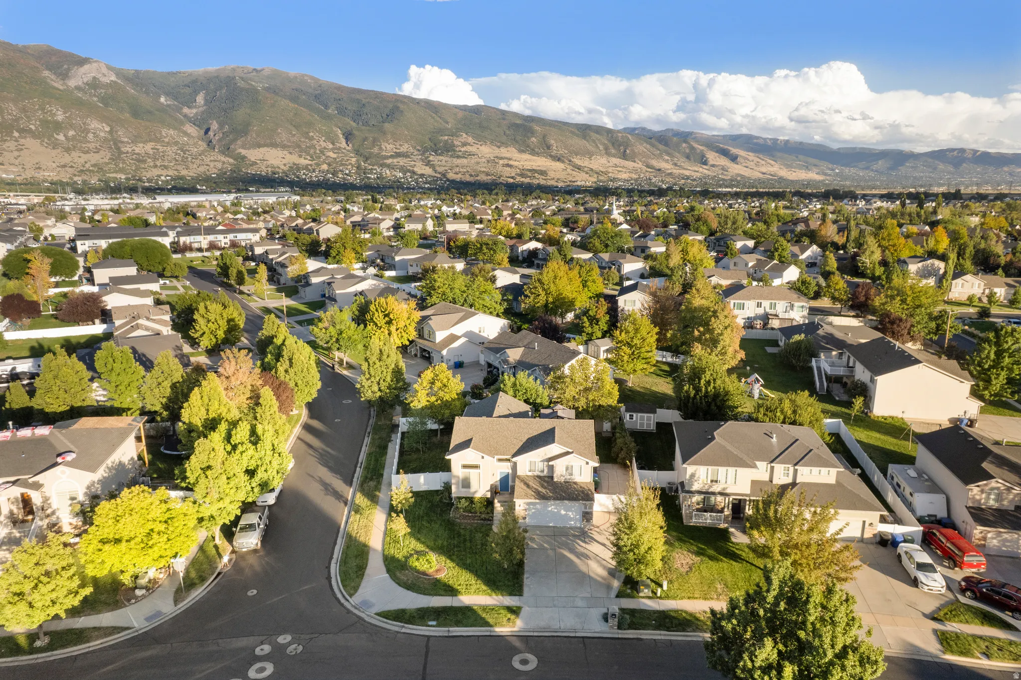 Expansive residential neighborhood with mature trees and mountain backdrop