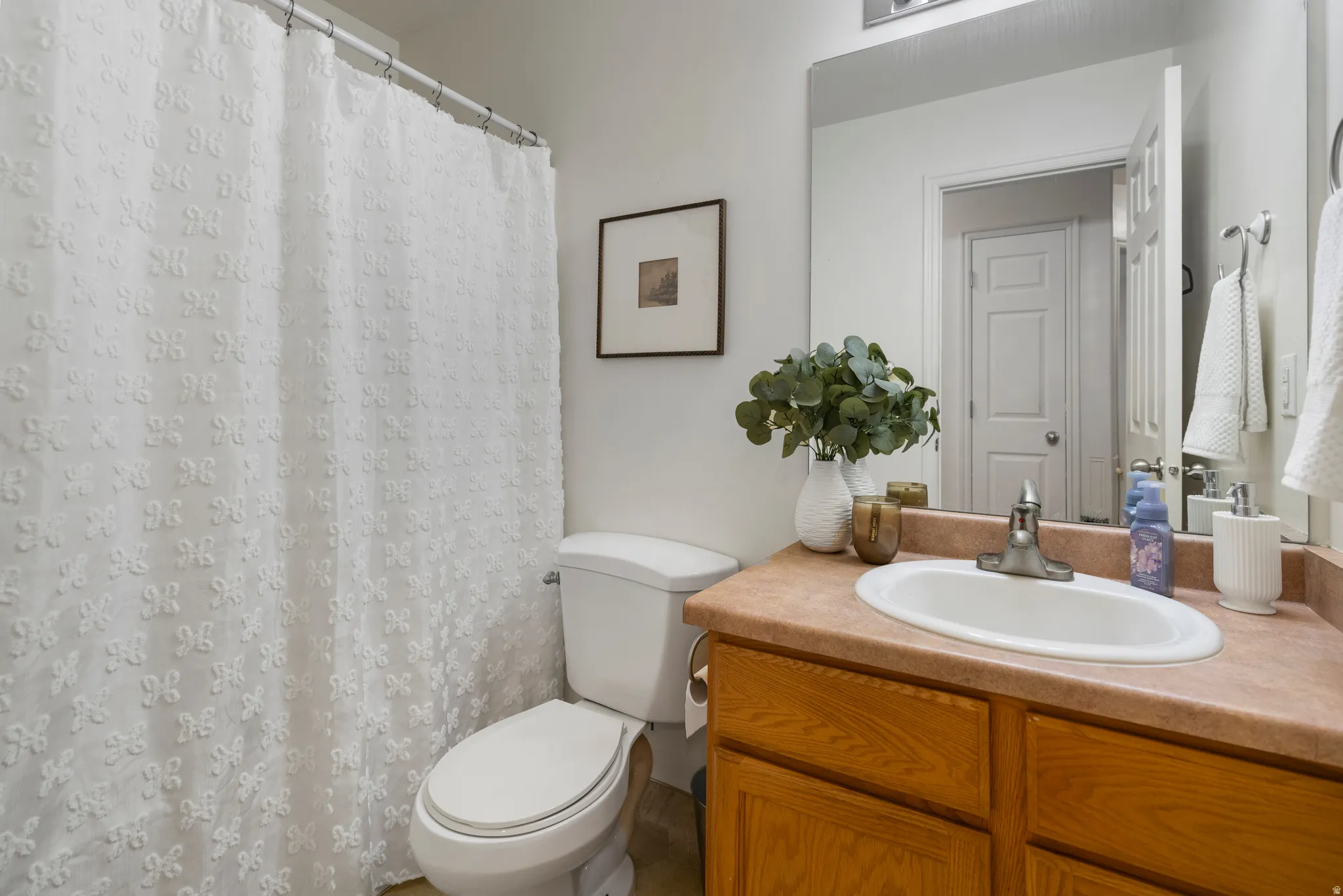 Vanity with an integrated sink, polished chrome faucet, and wood-finish cabinetry