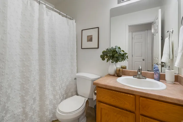 Vanity with an integrated sink, polished chrome faucet, and wood-finish cabinetry