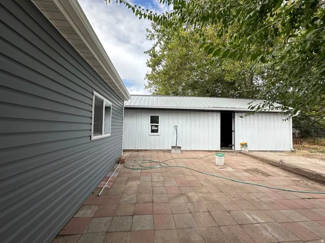 Slate grey siding with white window trim and gutter system