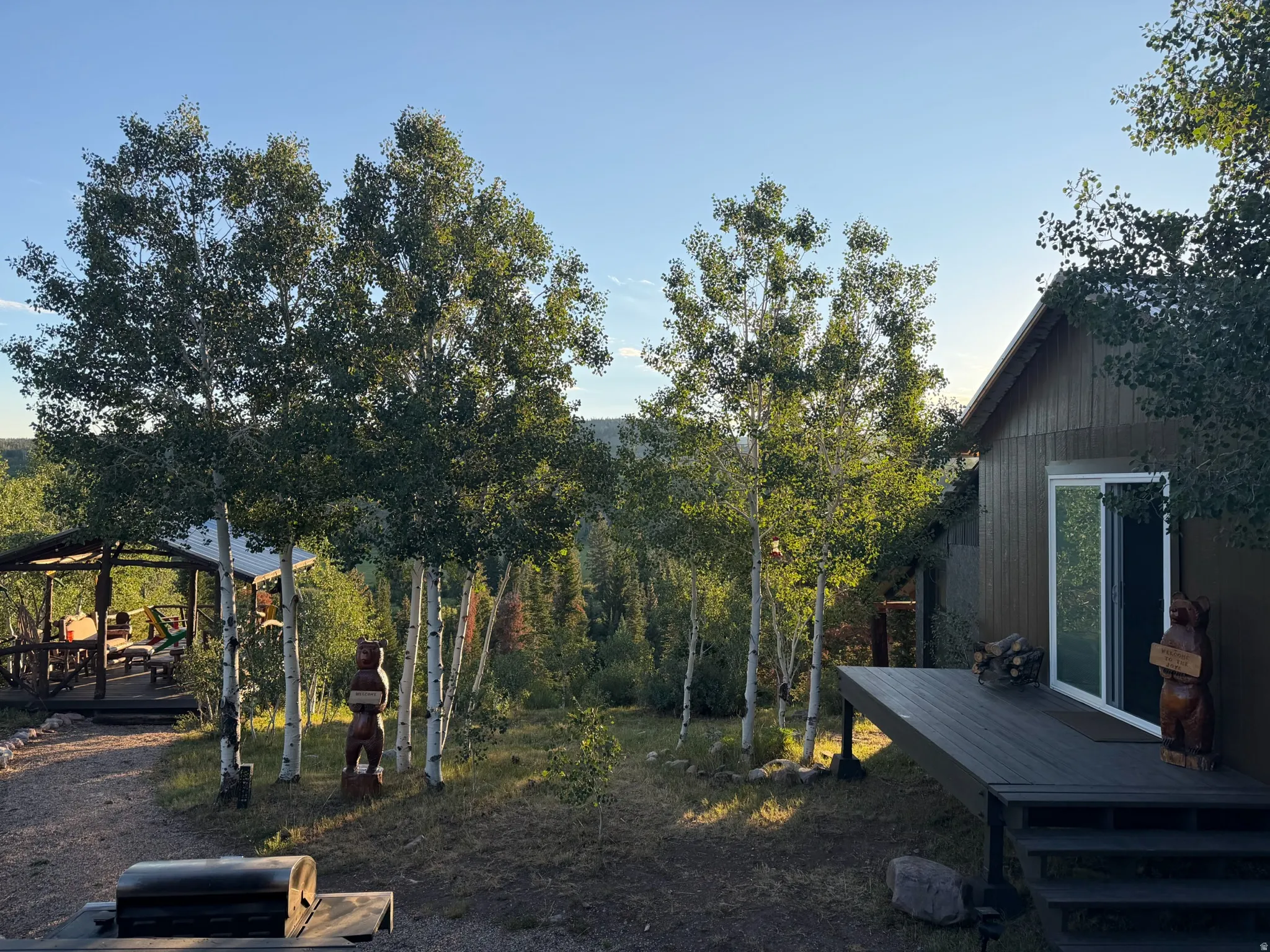Wood-sided exterior featuring a sliding glass door and an elevated deck with steps