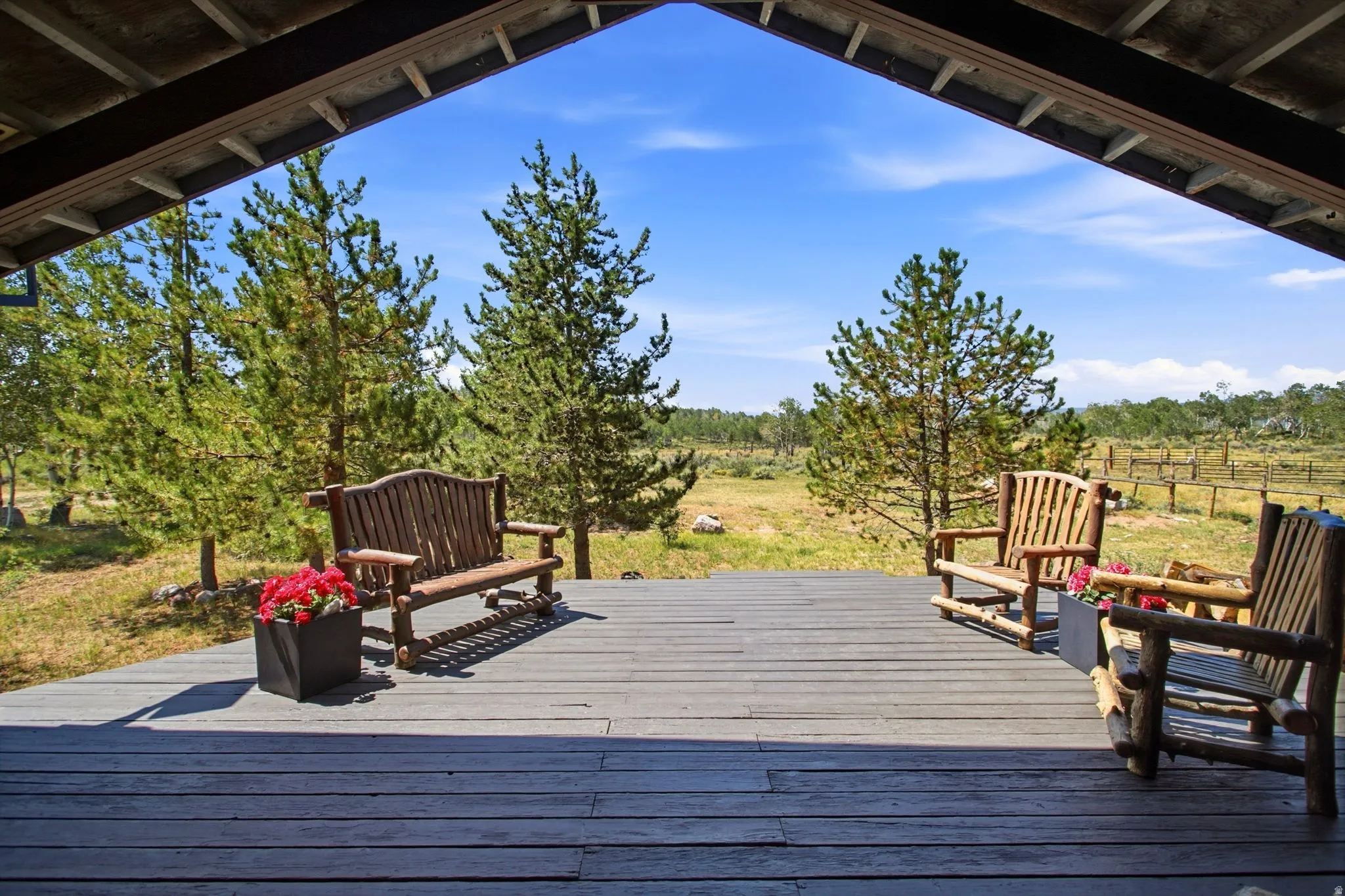 Expansive covered deck featuring wood-finish decking and exposed wood beams