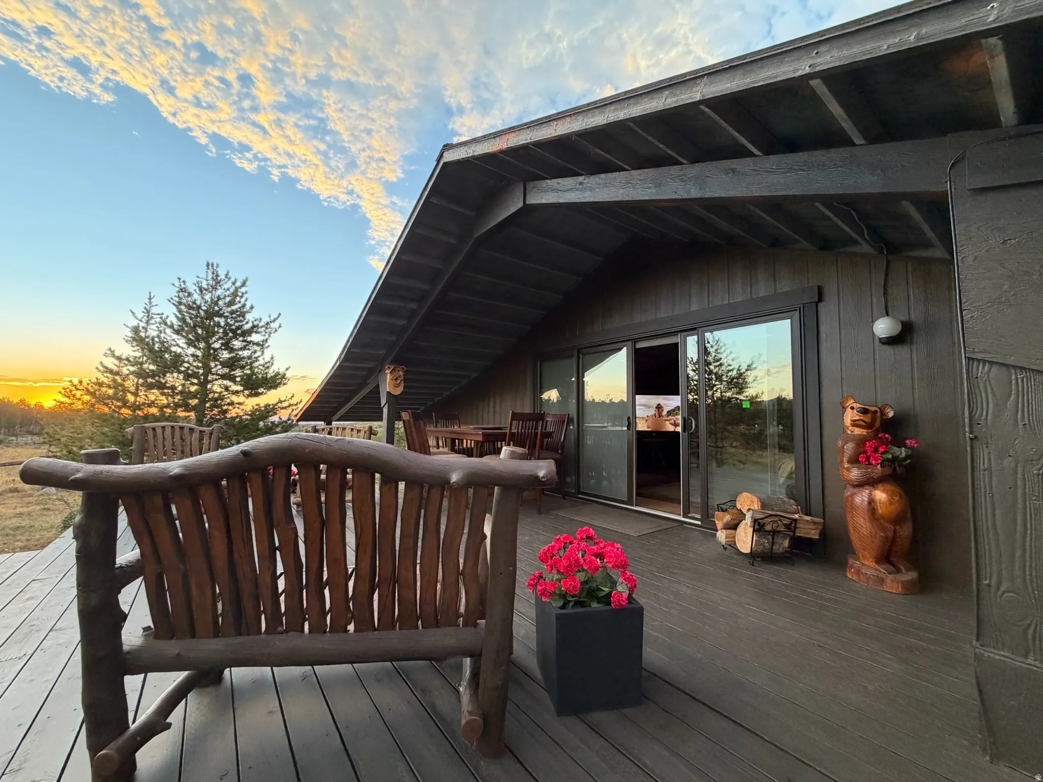 Expansive outdoor deck with a rustic wooden bench