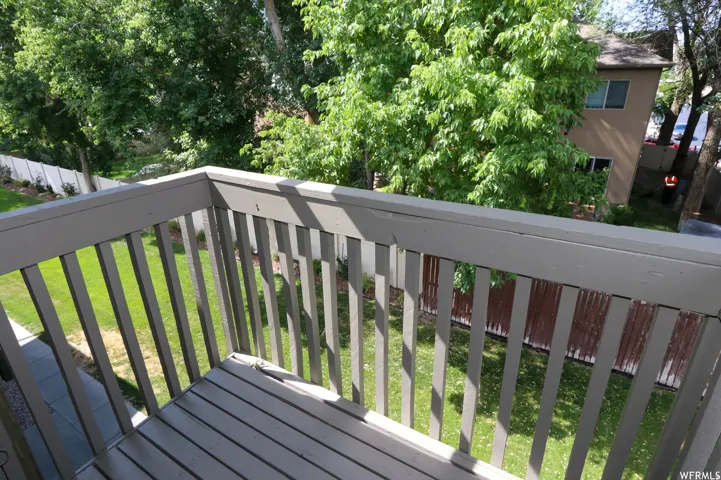 Private balcony with slatted wood-finish railing