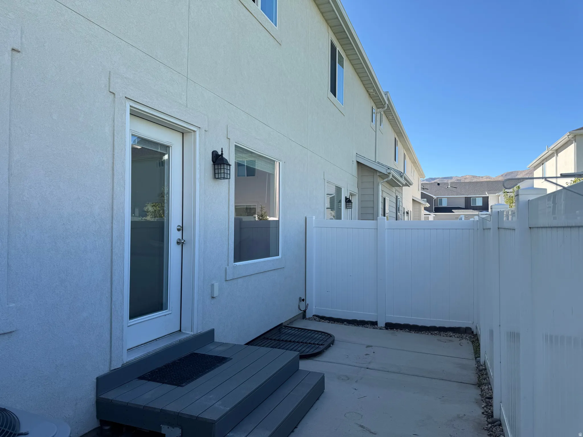 Rear patio access with composite steps and a privacy fence