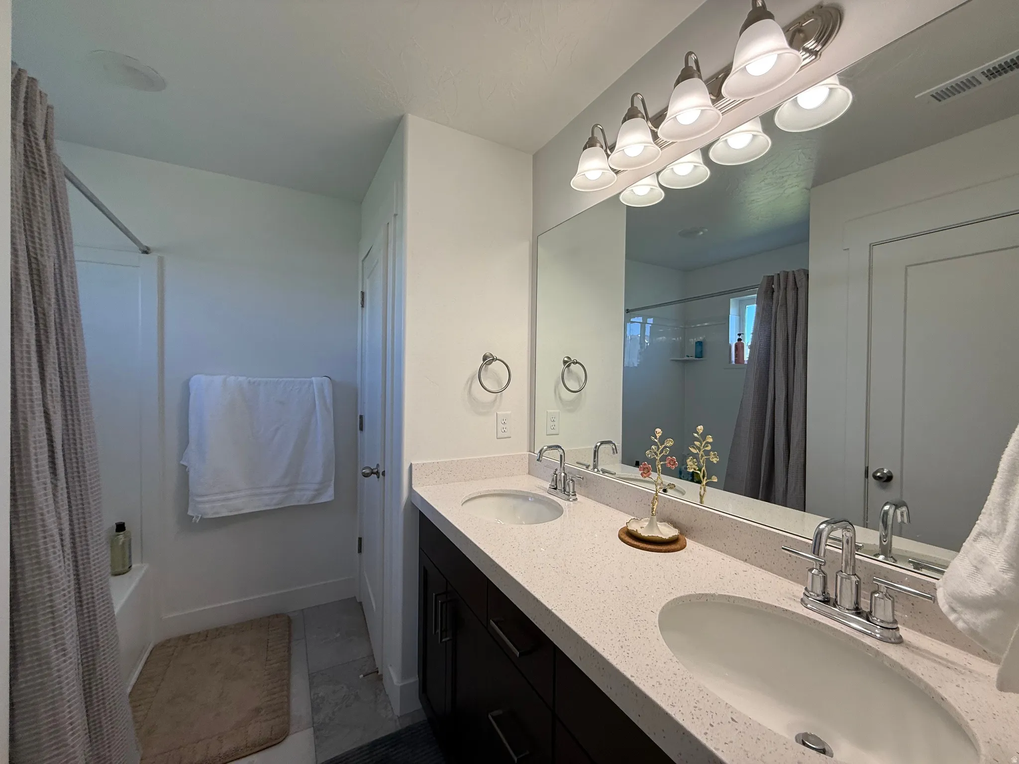 Dual vanity with chrome fixtures and light-colored countertops