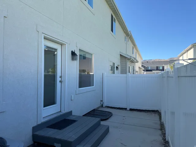 Rear patio access with composite steps and a privacy fence