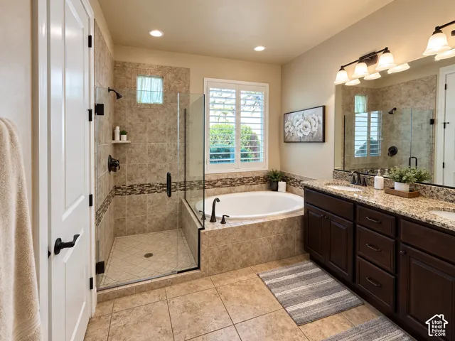 Primary Suite. Tile flooring leading to a built-in soaking tub and a separate glass-enclosed shower