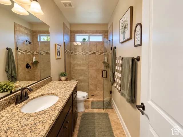 Full hall bath. Granite-look countertop with an undermount sink, dark wood-finish vanity, and bronze-finish fixtures