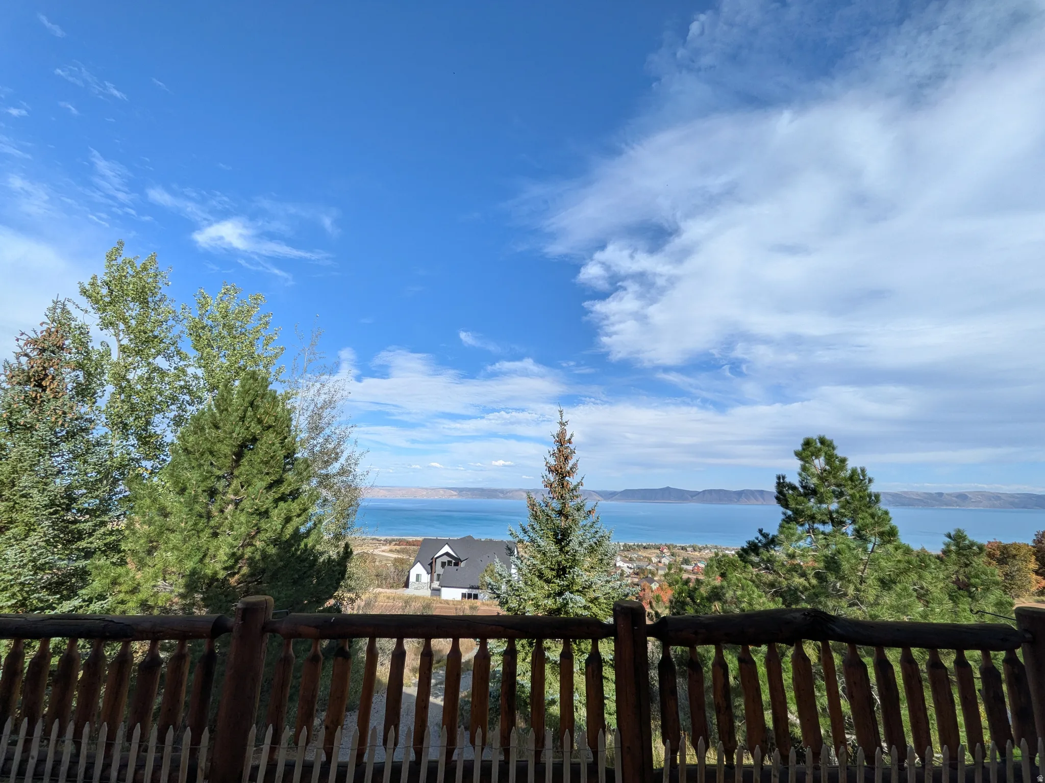 Expansive views of Beautiful Bear Lake, mountainous horizon, and mature trees